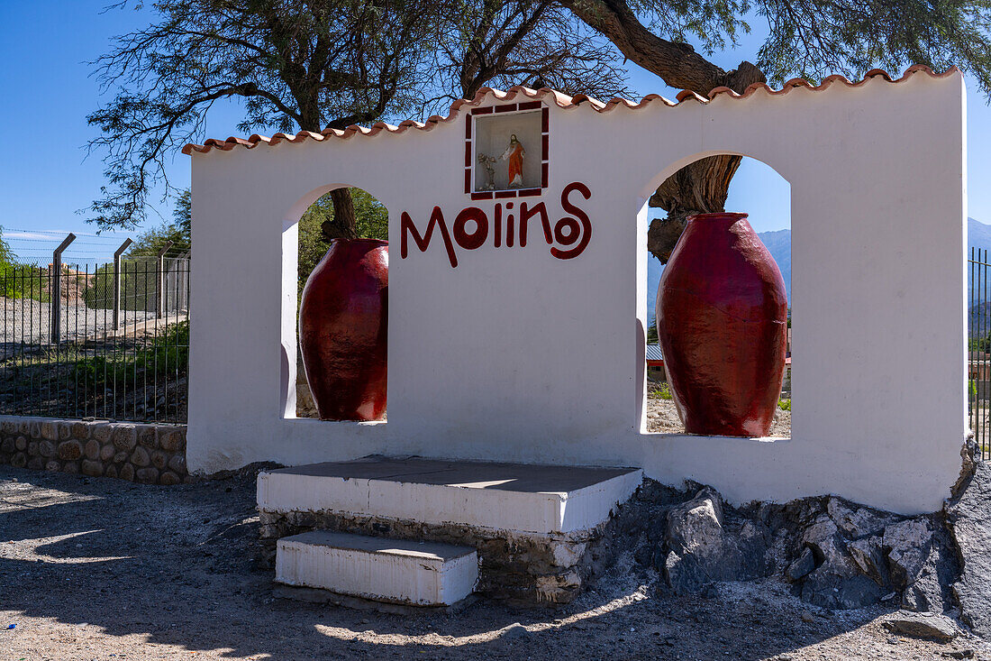 The colonial-style architecture welcome sign for the town of Molinos, Argentina in the Calchaqui Valley.