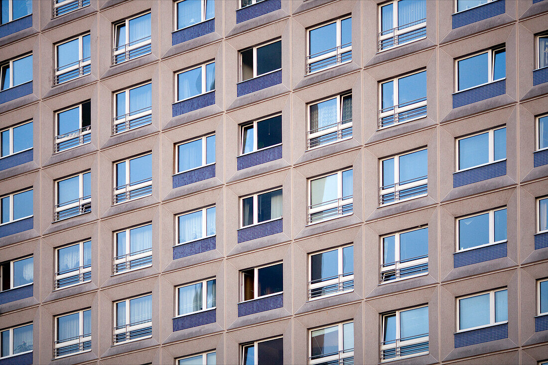 A close view of the modern facade of the Stelzenhaus, showcasing its unique window arrangement in Berlin\'s Mitte district.