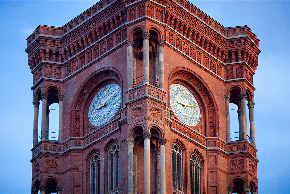 The clock on the Rotes Rathaus in Berlin stands tall, marking time against a beautiful sky, embodying the city\'s historical charm.