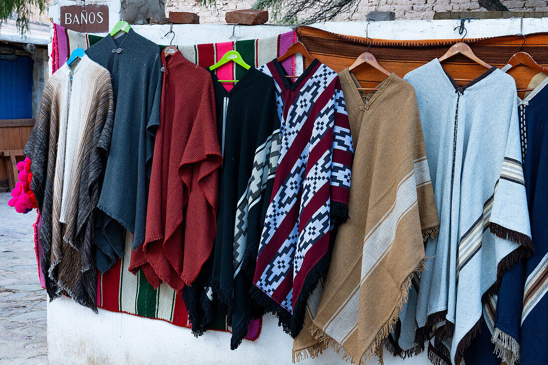 Woven ponchos made of llama and alpaca wool for sale in the open market on the square in Purmamarca, Argentina.