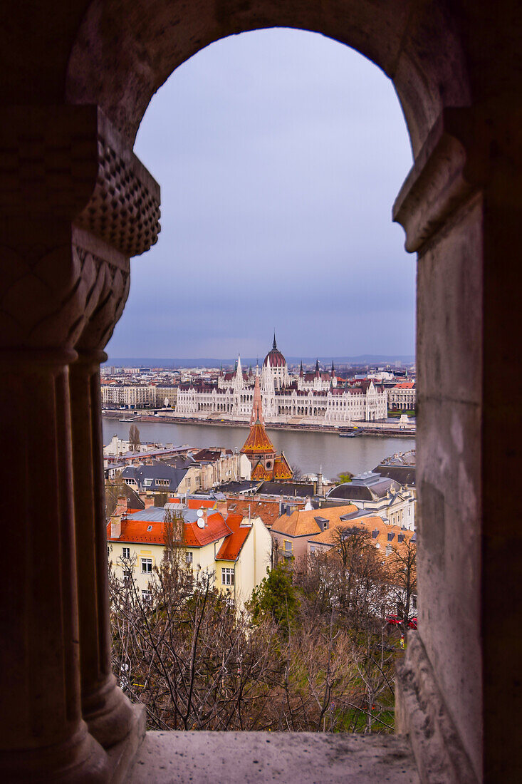 View of Parliament building, Chain Bridge and Danube River through old columns, Budapest, Hungary, Europe