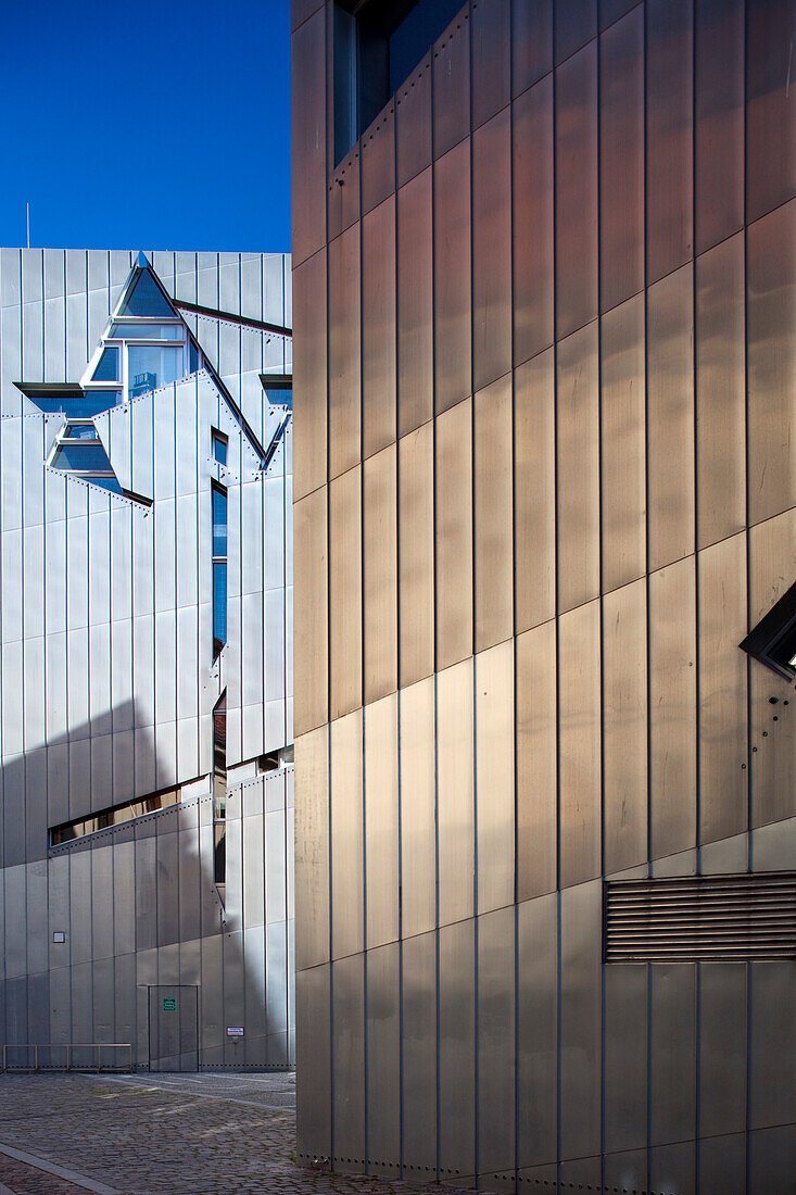 The striking architecture of the Jewish Museum stands out in Berlin, showcasing modern design elements and historical significance.