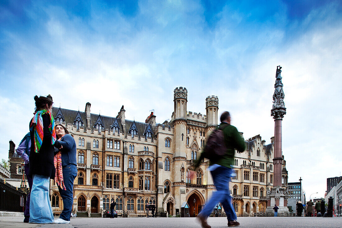 London, UK, May 2 2009, People stroll by the historic Broad Sanctuary building in Westminster, showcasing 19th century architecture against a vibrant sky.