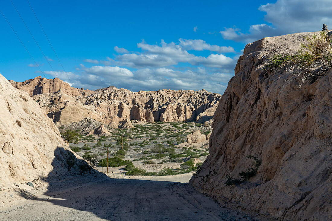 Route 40, an unpaved dirt road through the eroded landscape of the Angastaco Natural Monument in the Calchaqui Valley, Argentina.