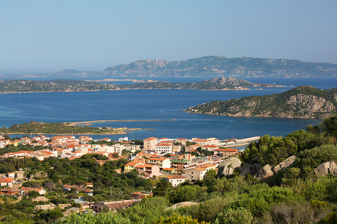 View from rocky hillside over town rooftops to the islands of Santo Stefano and Caprera, La Maddalena, La Maddalena Island, La Maddalena Archipelago National Park, Sassari, Sardinia, Italy, Mediterranean, Europe