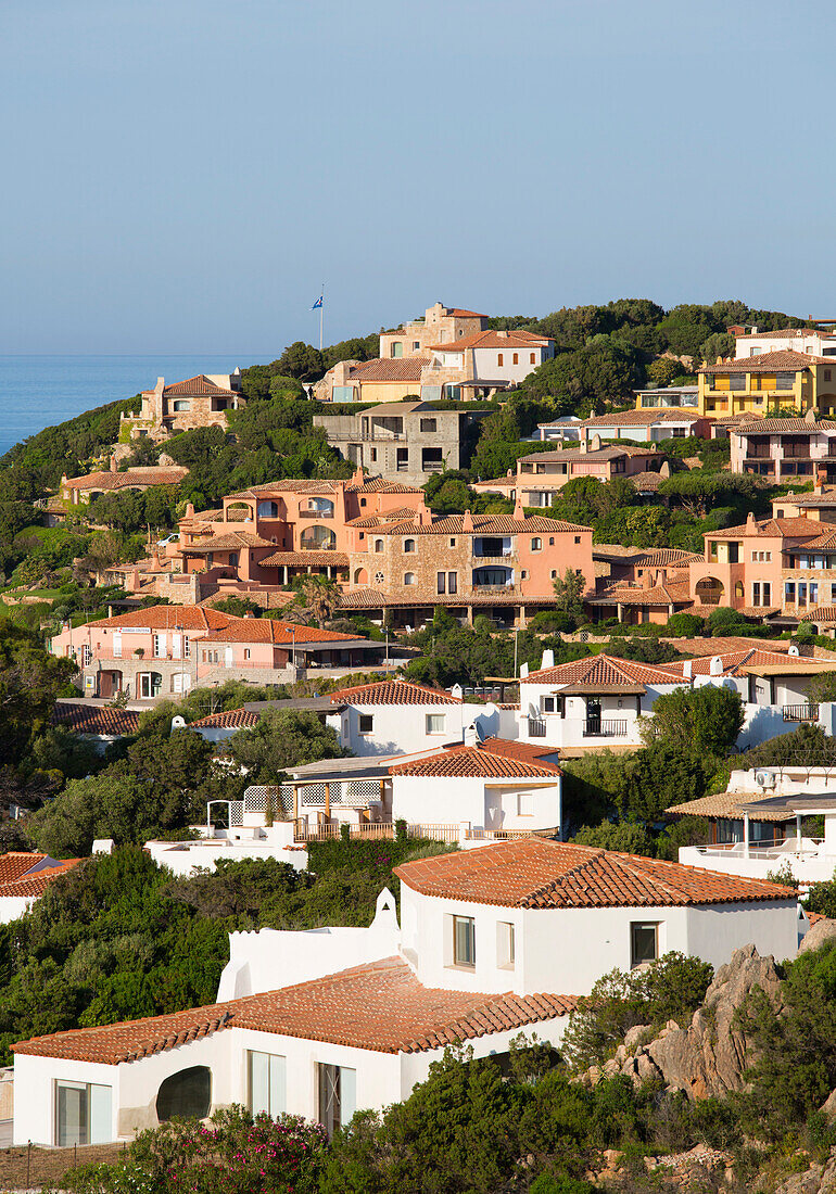 View over tiled rooftops to houses clinging to rocky hillside, Porto Cervo, Costa Smeralda, Arzachena, Sassari, Sardinia, Italy, Mediterranean, Europe