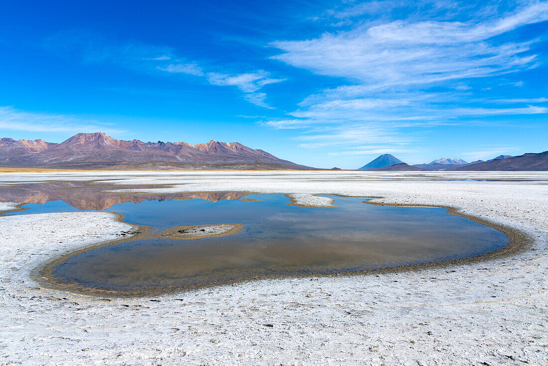 Reflection pool on salt flats and distant views of Pichu Pichu, El Misti and Chachani volcanoes, Salinas y Aguada Blanca National Reserve, Arequipa Province, Arequipa Region, Peru, South America