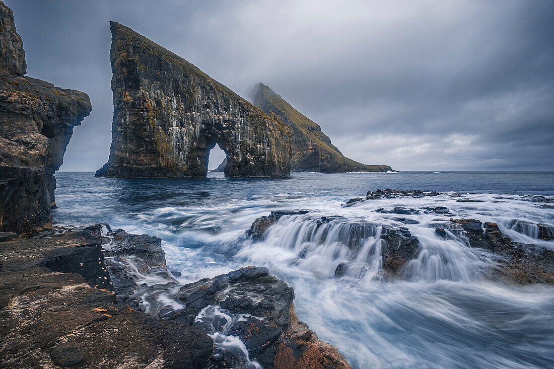 Dramatic Sea Arch of Drangarnir and  waves crashing on the Faroe Islands coast, Faroe Islands, Denmark, Atlantic, Europe