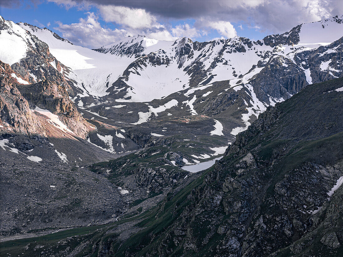 Snow-capped peaks and lush valleys at sunset showcased in a stunning landscape, Kyrgyzstan, Central Asia, Asia