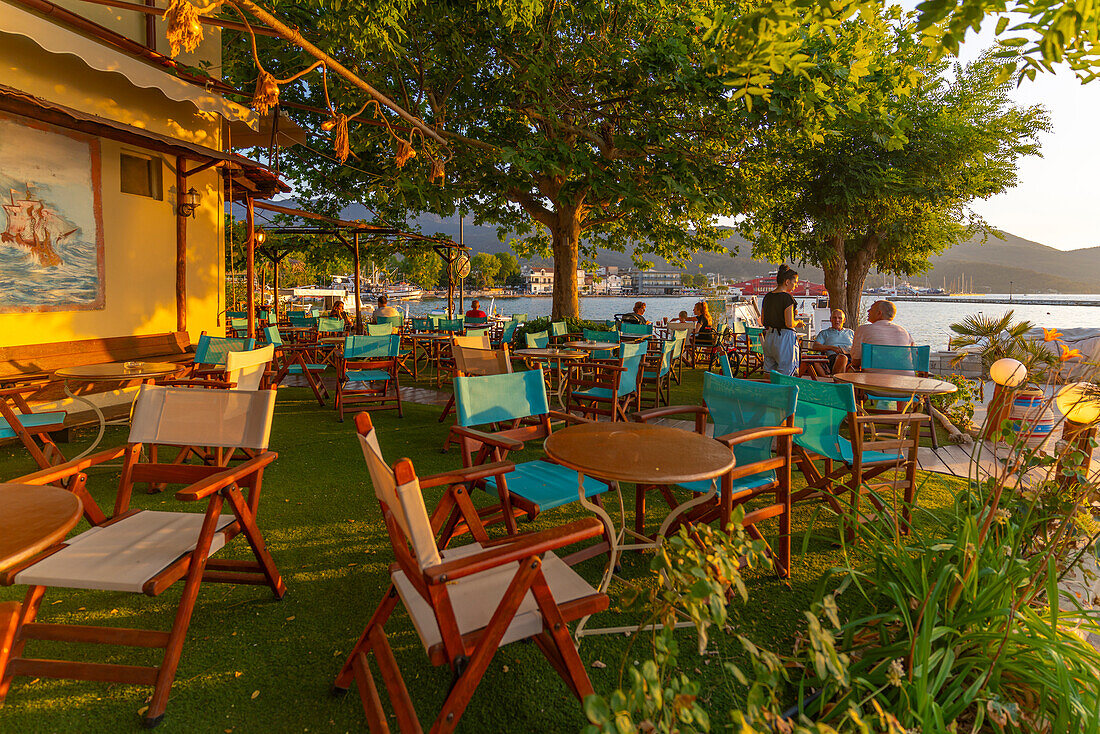 View of restaurant in old harbour in Thassos Town during golden hour, Thassos, Aegean Sea, Greek Islands, Greece, Europe