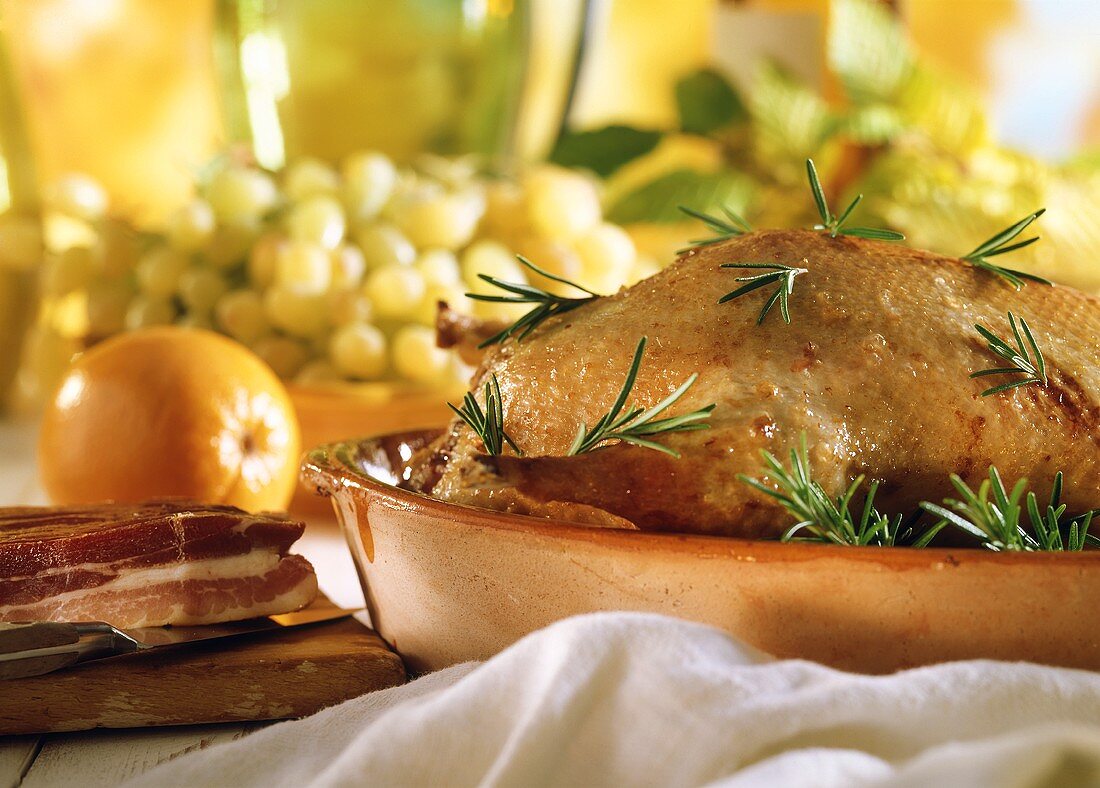 Roast duck with rosemary in the roasting dish