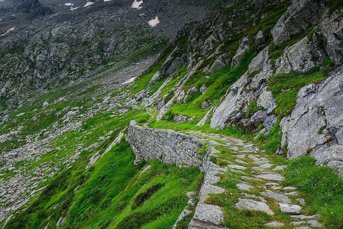 Beautiful hiking path on steep rocky and grassy slopes in the Italian Alps, Colle del Turlo, Vercelli, Piedmont, Italy, Europe