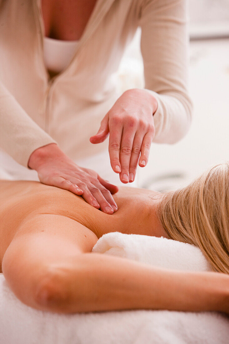 Woman lying on stomach receiving a massage