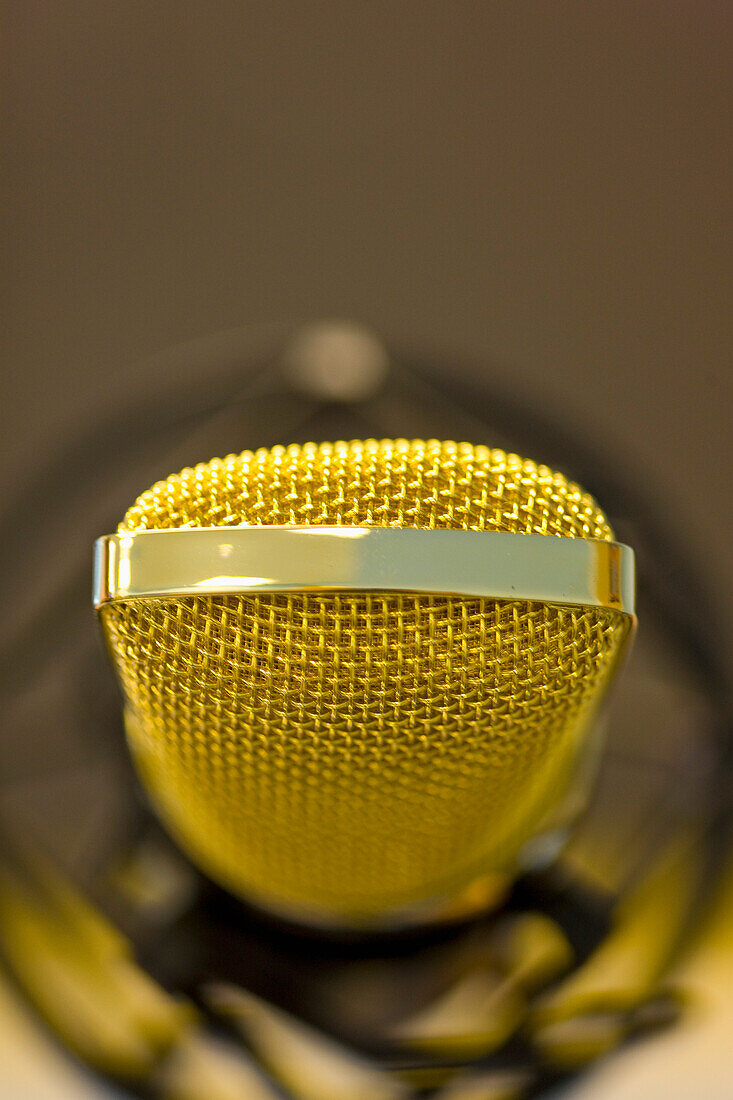 Extreme close up of a gold microphone