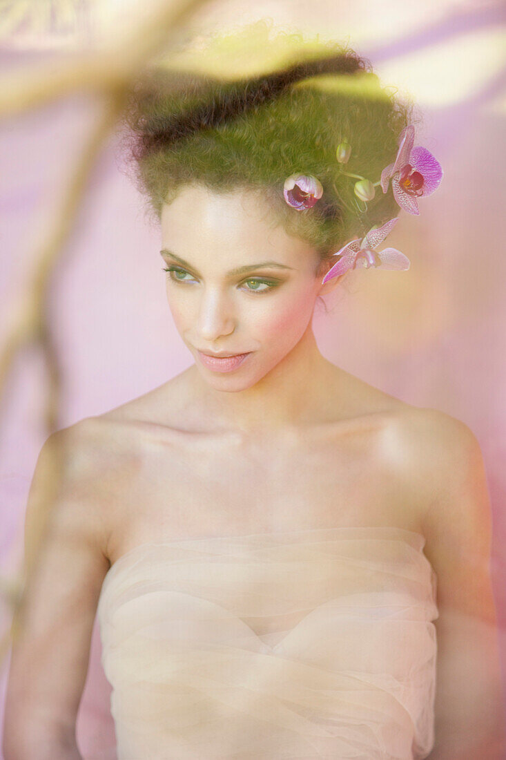 Young Woman with Orchids in Hair Behind Pane of Glass