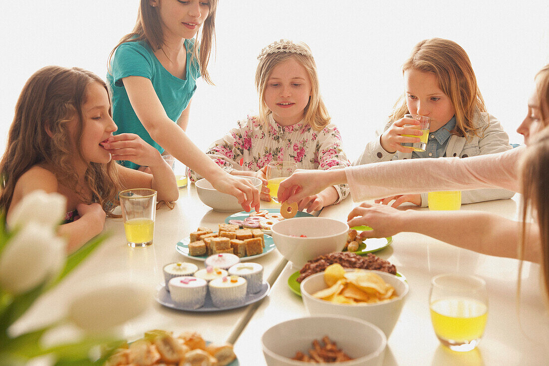 Group of Girls Eating and Drinking Around Table