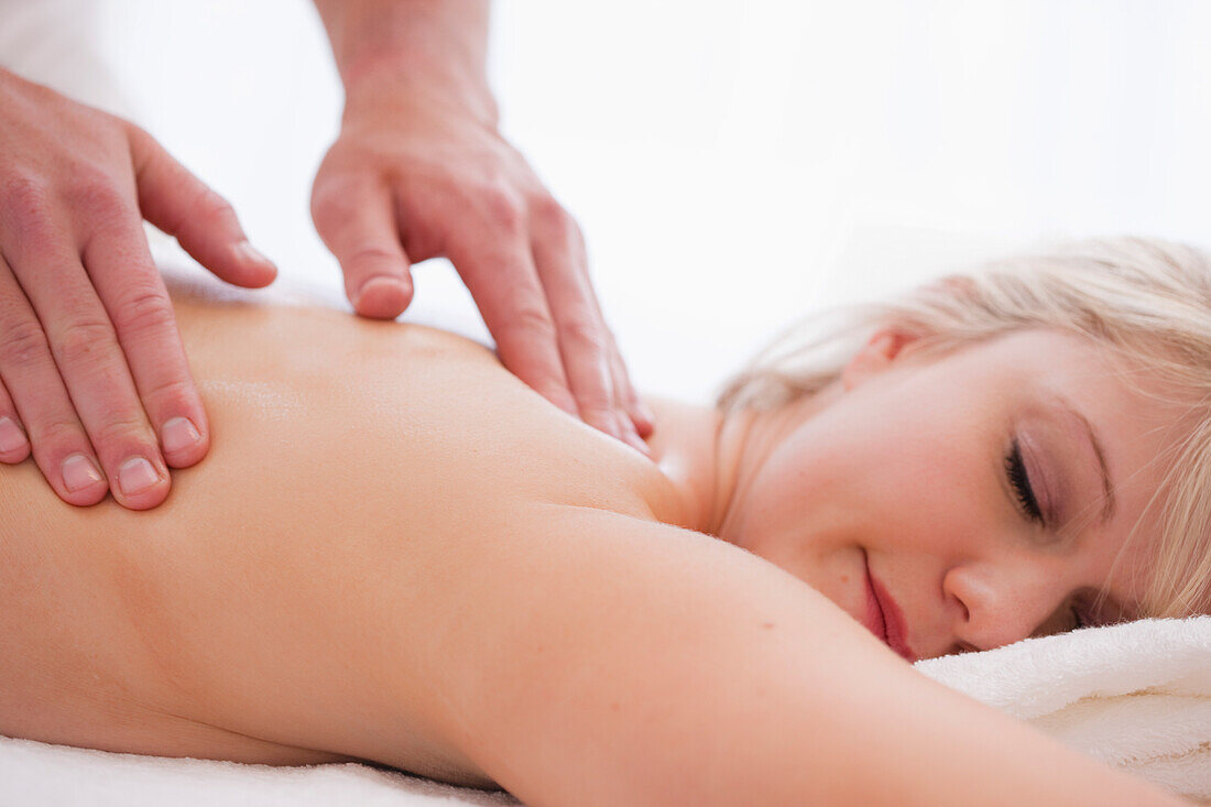 Close up of a masseur hands giving a woman a massage