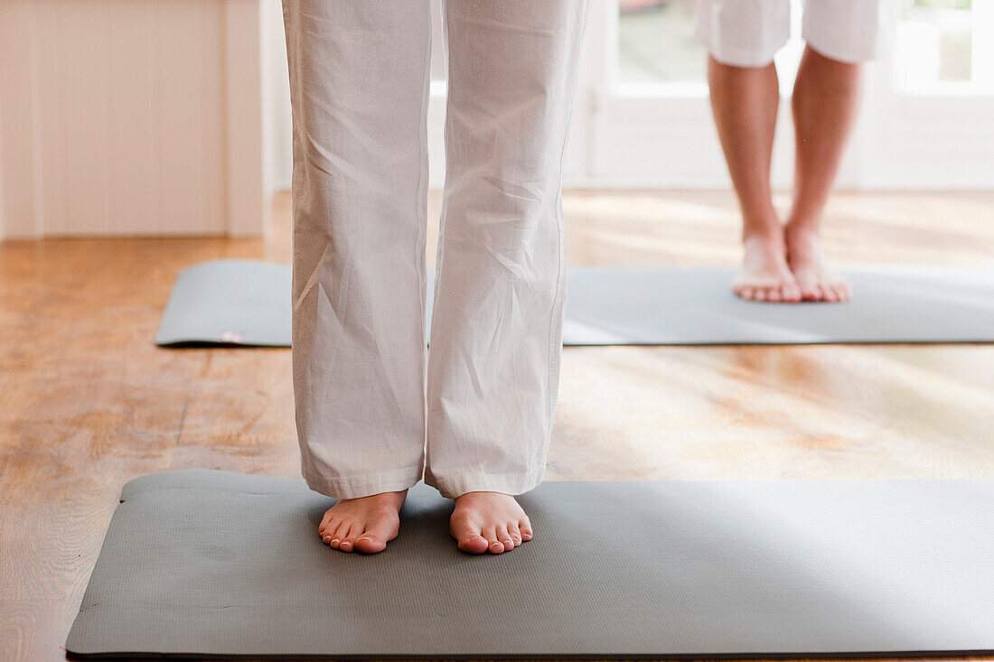 Two people legs and feet during a yoga practice