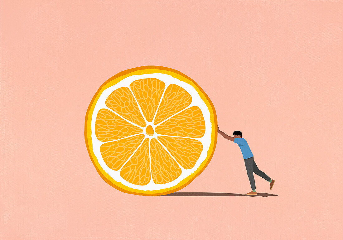 Man pushing large orange slice on pink background