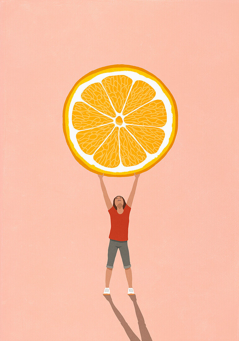 Happy girl holding large orange slice overhead on pink background