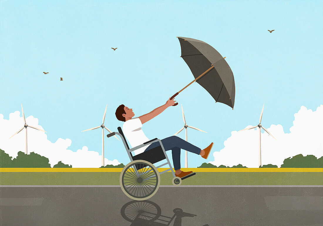 Man in wheelchair using umbrella as sail in wind in countryside with wind turbines