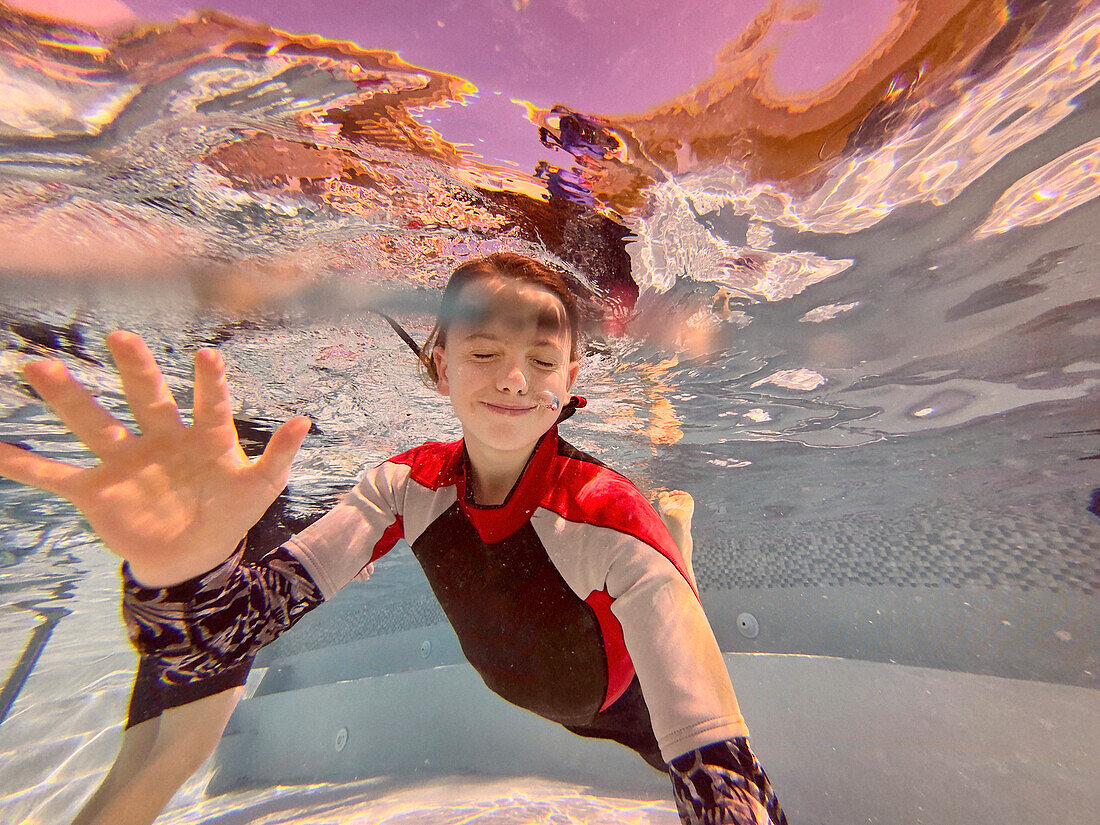 Portrait happy boy swimming underwater in swimming pool, Kingstown, Saint Vincent and the Grenadines