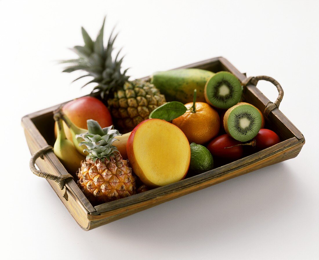 Various exotic fruits on wooden tray