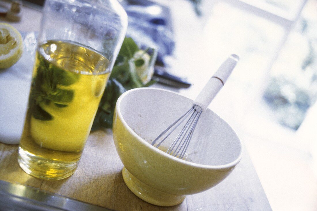 Marinade im Schälchen und Flasche Olivenöl auf Küchentisch