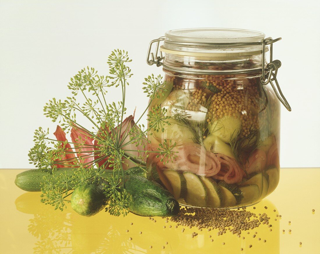 Pickled gherkins with courgettes in jar