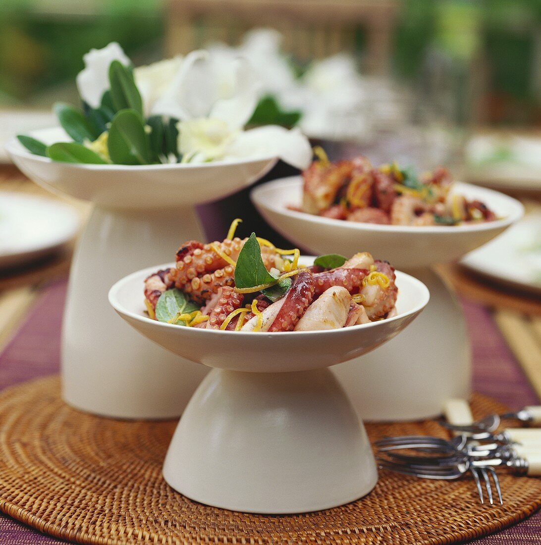 Cuttlefish salad with orange zest in Asian bowls