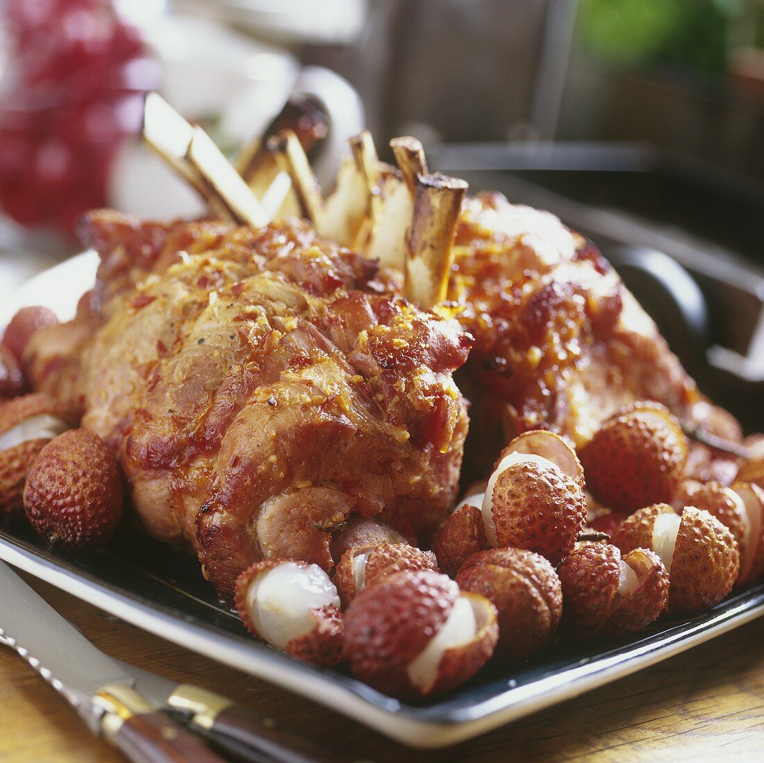 Roast pork ribs with lychees on baking sheet