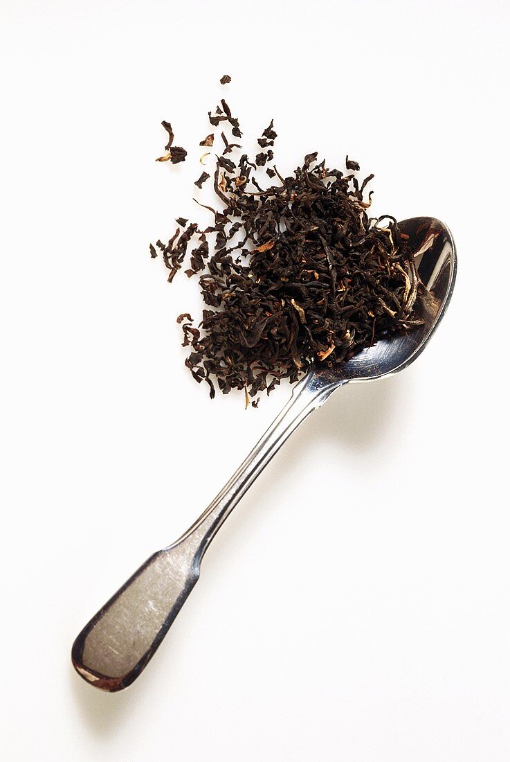 Loose black tea on silver teaspoon