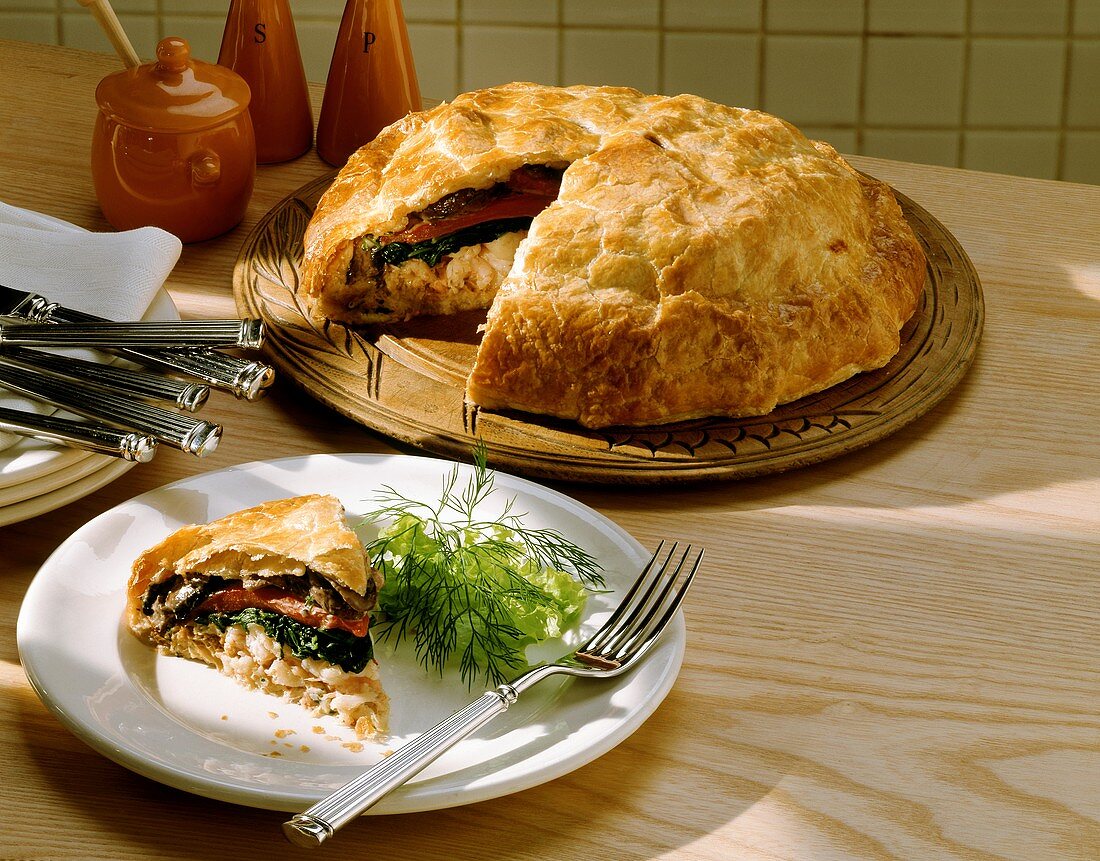 Vegetable and shrimp pie with mushrooms, a piece cut