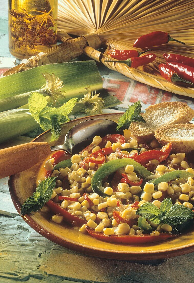 Creole corn stew with peppers and mint on plate