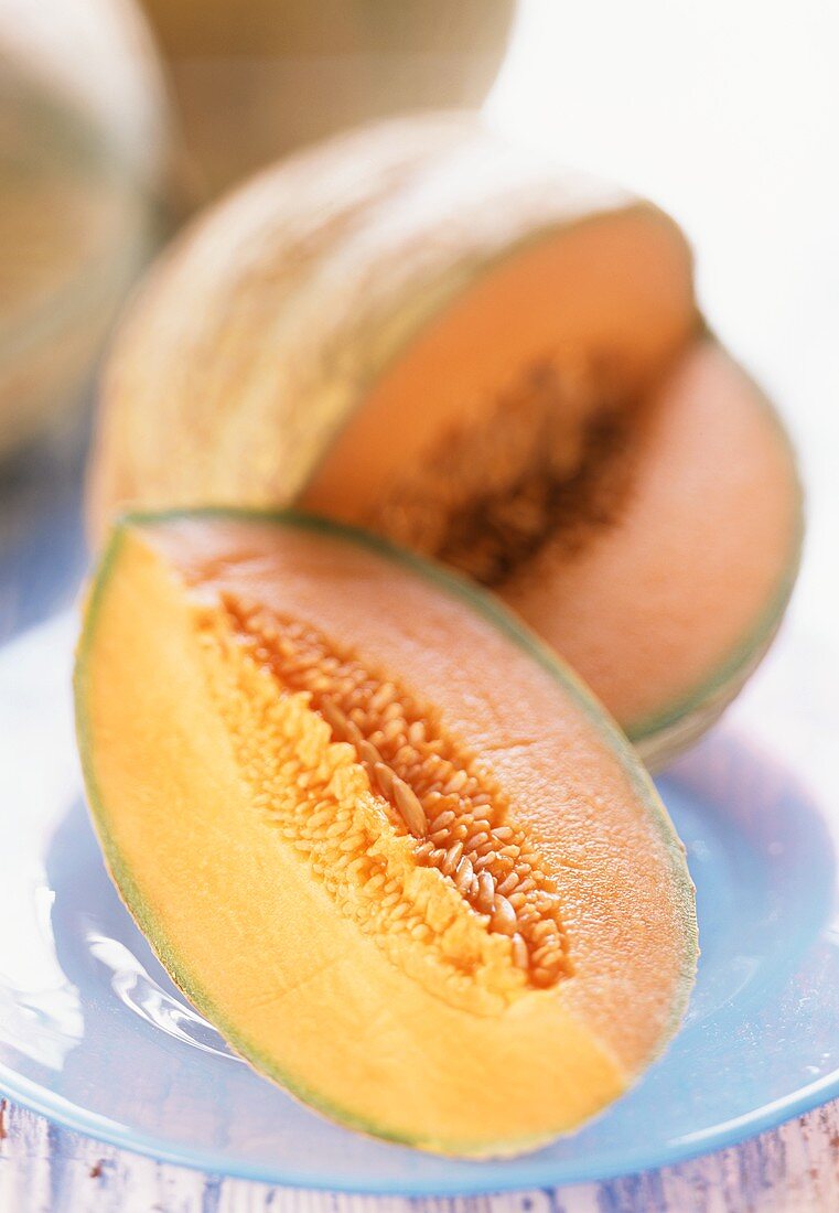 Cavaillon melon with slice of melon on plate