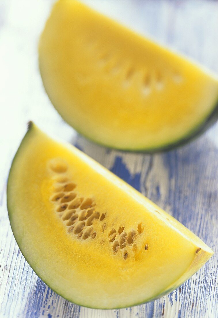 Two wedges of pineapple melon (yellow water melon)