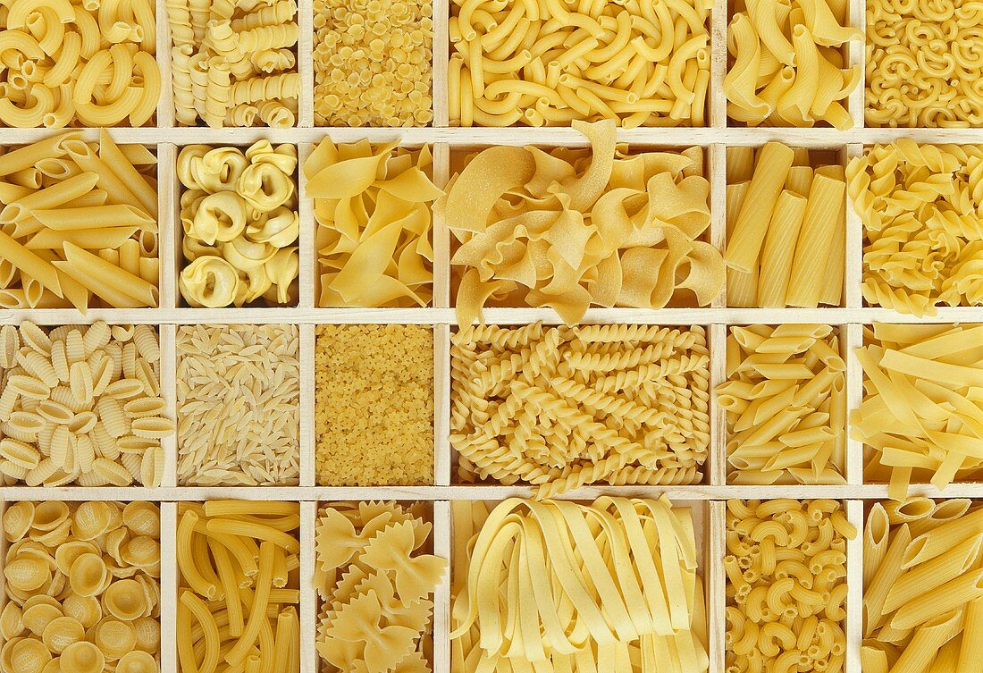 Still life: various types of pasta in white typesetter's case