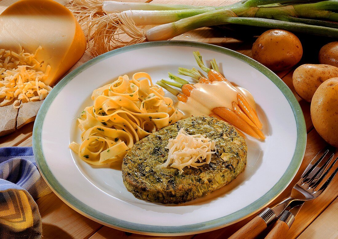 Potato and leek burger with carrots and pasta