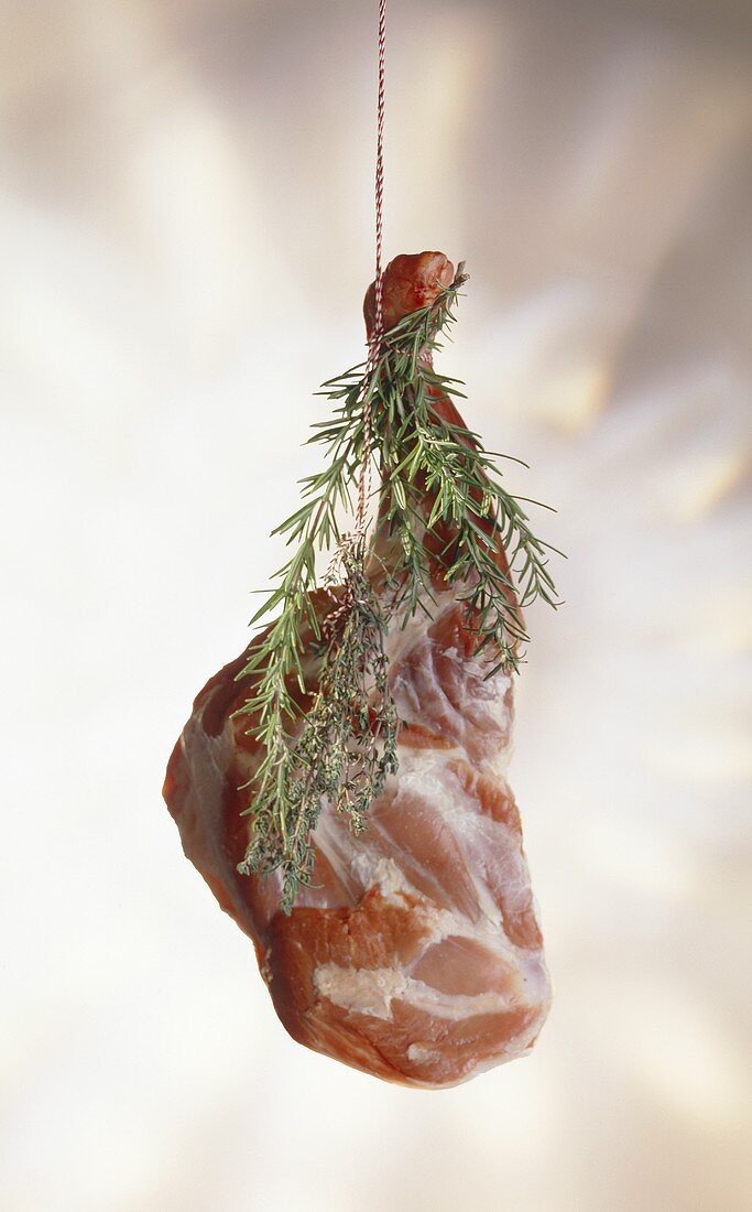 Leg of lamb with sprigs of rosemary
