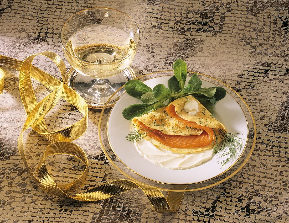 Herb crepe filled with salmon trout and a glass of champagne