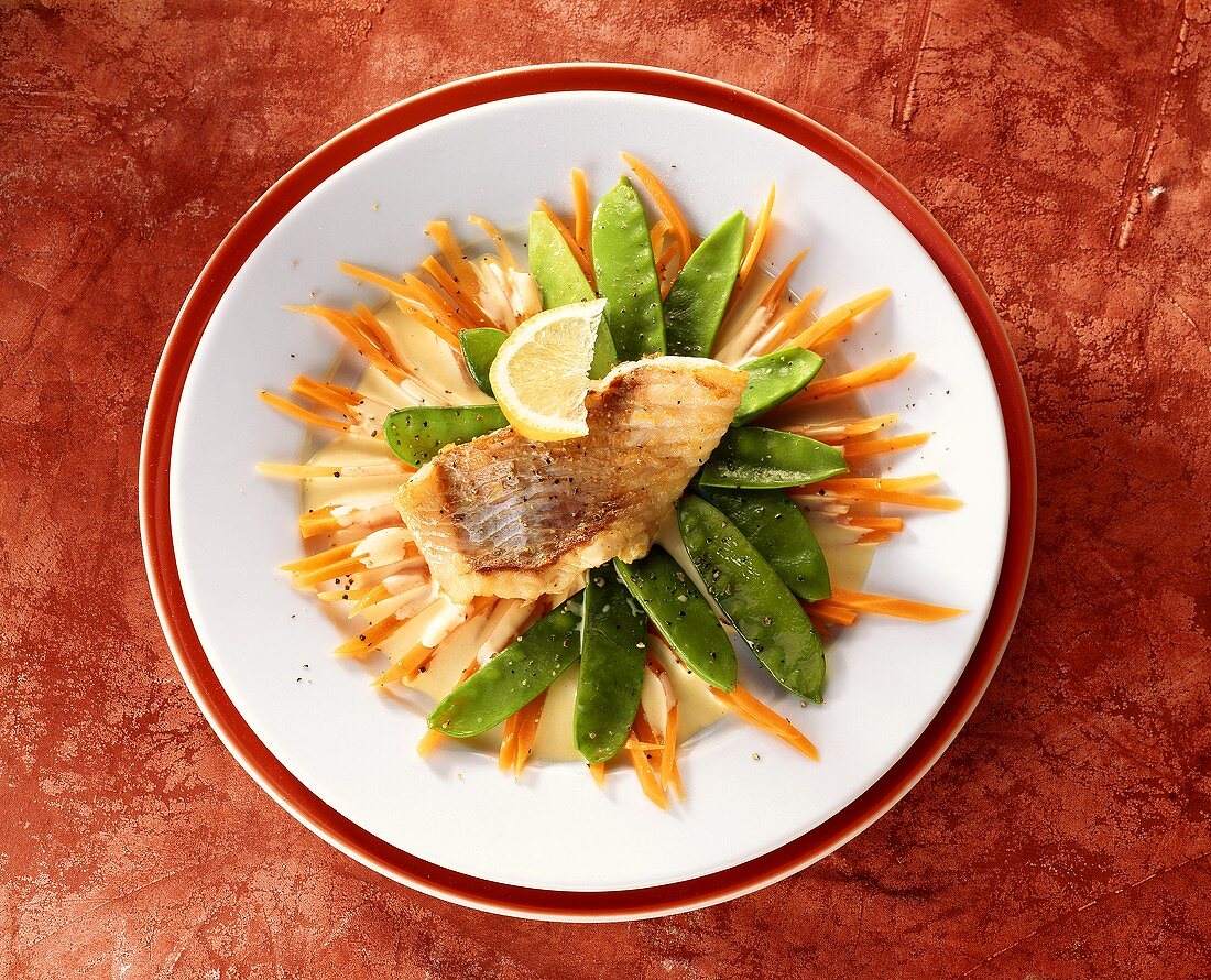 Fried red perch fillet with mangetouts and carrots