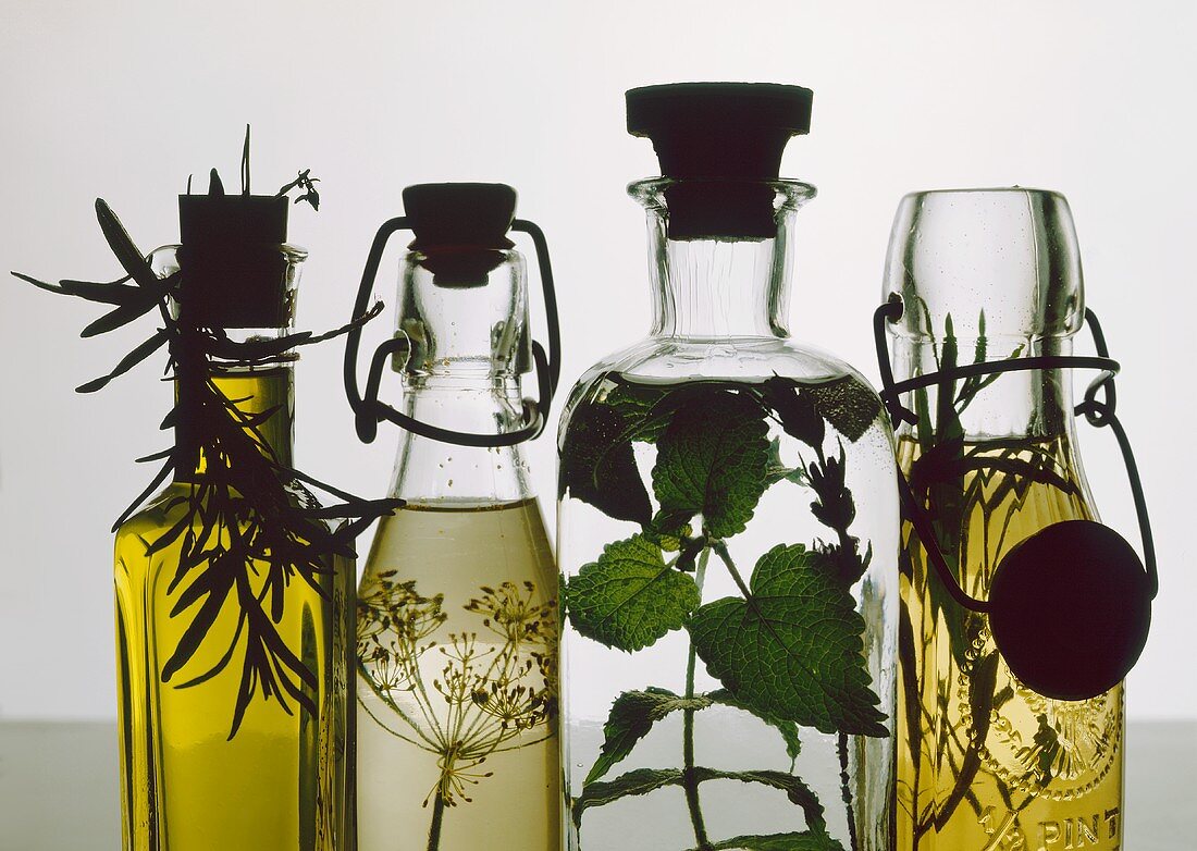 Four bottles of herb vinegars and herb oil