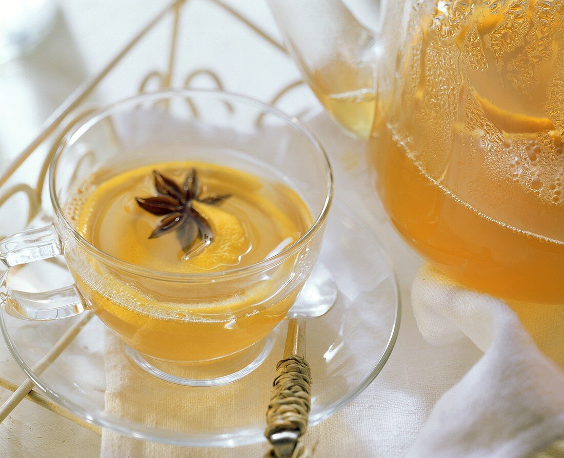 Lemon tea punch with star anise in glass cup