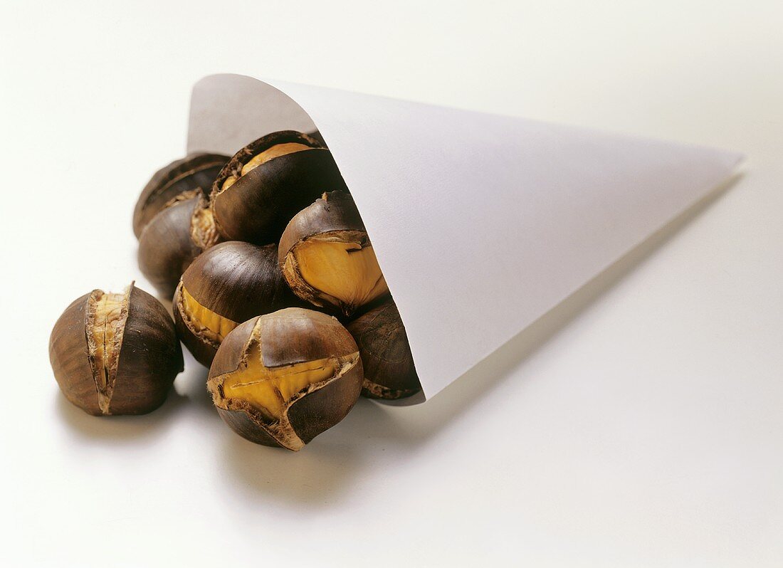 Roasted chestnuts falling out of paper bag