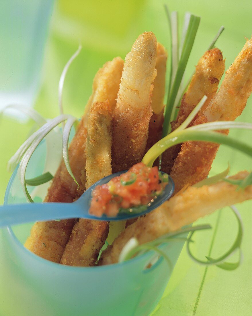 Fried asparagus stalks with tomato dip