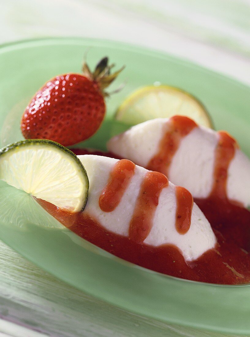 Yoghurt and lime mousse with strawberry sauce