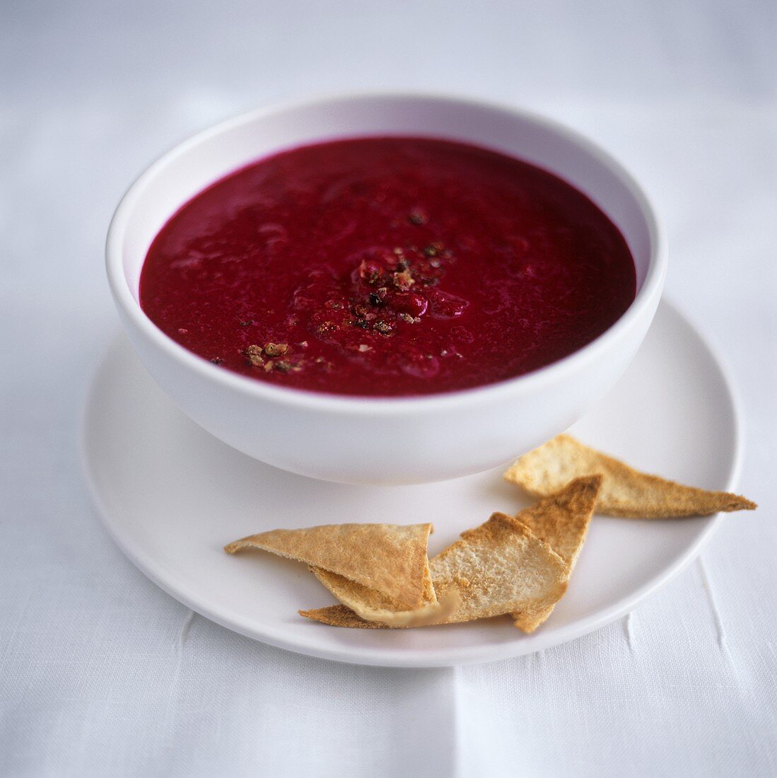 Beetroot soup in bowl, with taco chips