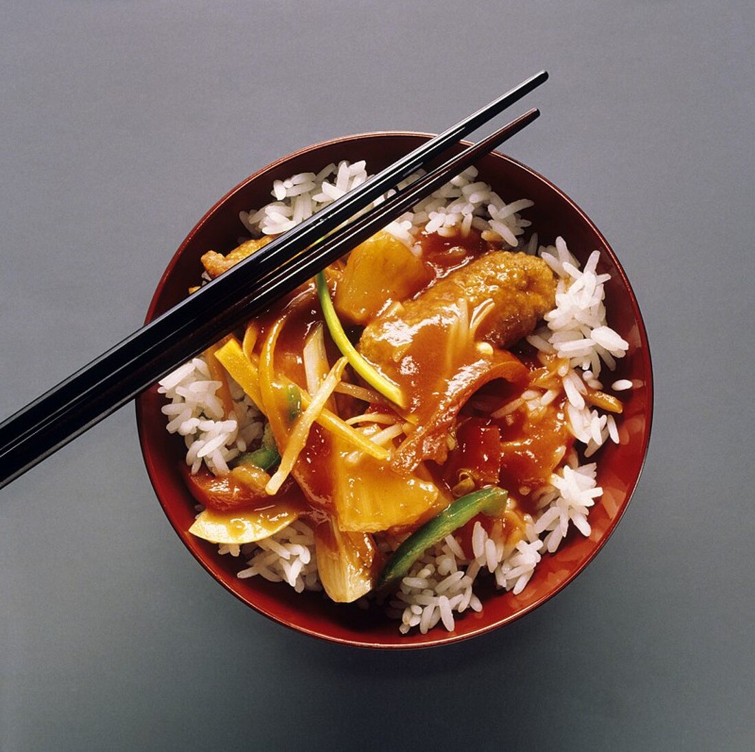 Sweet and sour pork with rice in bowl