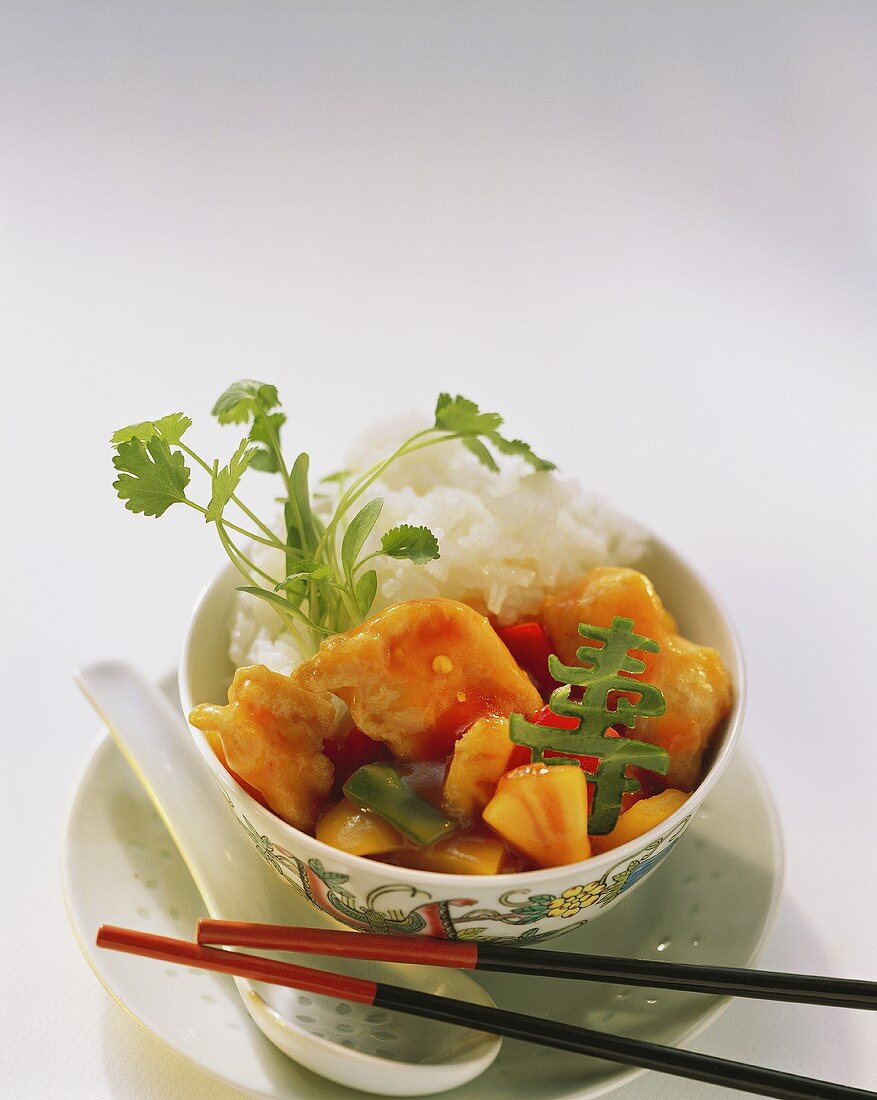 Sweet and sour chicken with rice in dish