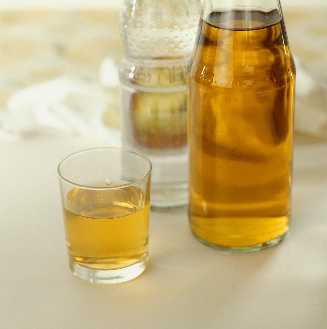 Glass of apple drink, apple juice & mineral water bottle